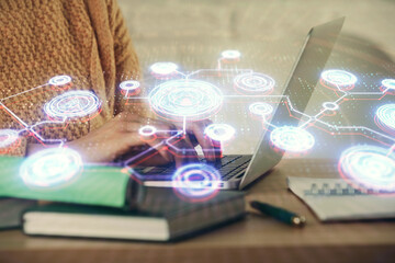 Fototapeta premium Double exposure of woman hands typing on computer and social network theme hologram drawing. People media concept.