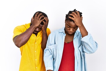 Young african american couple wearing casual clothes suffering from headache desperate and stressed because pain and migraine. hands on head.