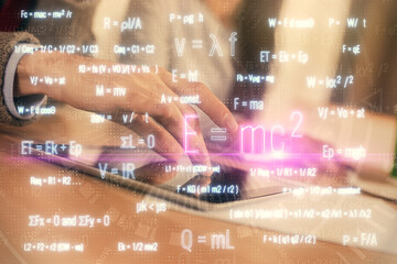 Obraz premium Double exposure of formulas hologram drawing and man and woman working together holding and using a mobile device. Education concept