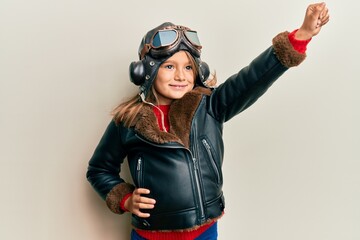 Little girl dressed as plane pilot wearing helmet and aviatior glasses © Krakenimages.com