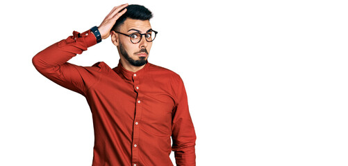 Young hispanic man with beard wearing business shirt and glasses confuse and wonder about question....