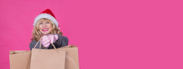 woman with christmas santa hat and shopping bags