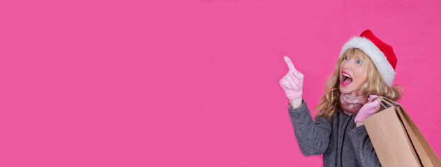 woman with christmas santa hat and shopping bags