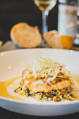 Sea bass roasted in curry butter, cauliflower,.pine nuts, coriander.