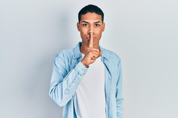 Young african american guy wearing casual clothes asking to be quiet with finger on lips. silence and secret concept.