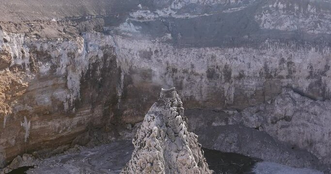 The crater of the volcano Ol Doinyo Lengai. Smoke comes from a volcano in the mountains of Africa.
