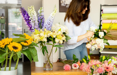 Small business. Female florist in flower shop. Floral design studio, making decorations and arrangements. Flowers delivery, creating order.