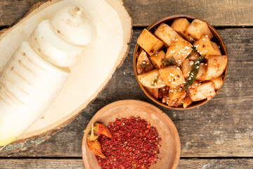 Radish daikon made in Korean top view. Wooden background.