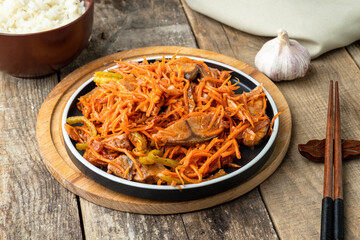 Marinated khe fish in Korean on a wooden background.