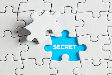 To expose or discover a secret. The word secret on blue missing puzzle piece.