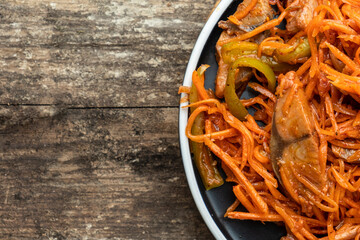 Salad with pickled fish and carrots. View from above. Free space.