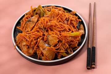 Korean salad with fish on a pink background. Fish heh.