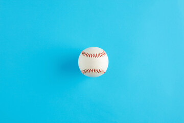 Baseball ball on blue background with copy space.