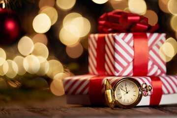 clocks and Christmas boxes on a festive background.