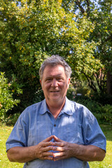 Fototapeta premium handsome senior man in the garden with positive smiling face