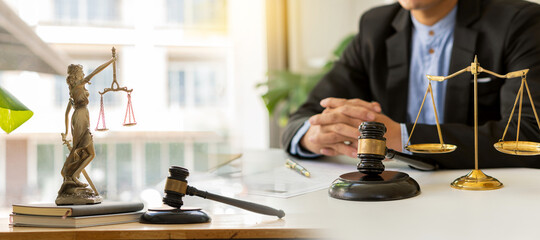 Lawyer Counseling Law Male judge in the courtroom on wooden table with hammer and scales and working in office Legal concepts, advice and justice