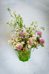 Bouquet of wild natural flowers, selective focus. Wildflowers  in vase on vintage background