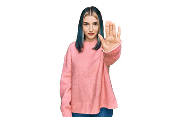 Young modern girl wearing pink wool winter sweater doing stop sing with palm of the hand. warning...