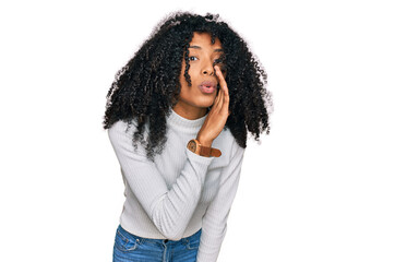 Fototapeta na wymiar Young african american girl wearing casual clothes hand on mouth telling secret rumor, whispering malicious talk conversation