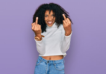Young african american girl wearing casual clothes showing middle finger doing fuck you bad...