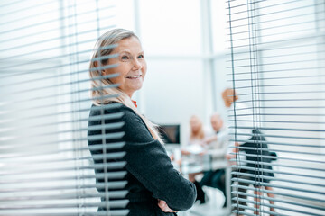 confident woman Manager standing in spacious office.