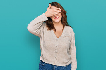 Young plus size woman wearing casual clothes smiling and laughing with hand on face covering eyes for surprise. blind concept.