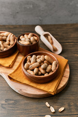 Image of wooden spoons with peanuts on a wooden table