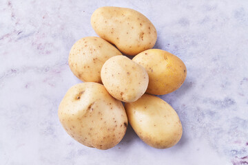  Bunch of potatoes on a marble surface