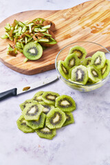  Slices of peeled kiwi on a marble surface