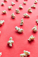  Bunch of salty popcorns on a red background