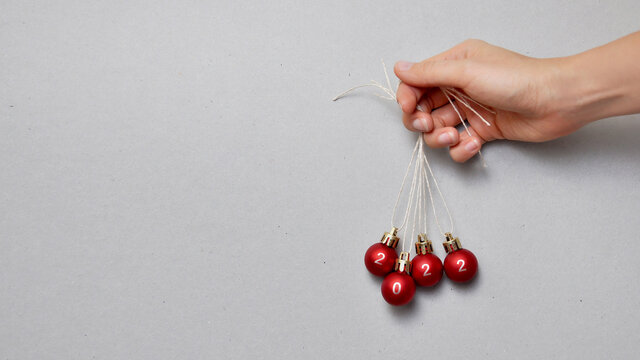 four red Christmas balls with the inscription 2022. The new year is coming soon