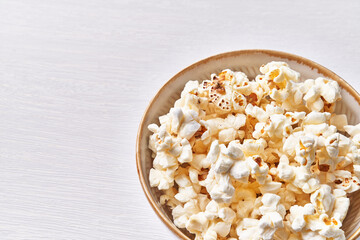  Bowl of salty popcorns isolated on a white background