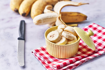  Bowls of slices of banana on a marble table