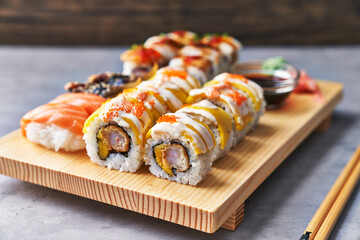  Wooden board of sushi food on a concrete surface