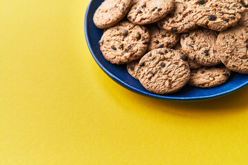  Plate of chocolate cookies on a yellow background