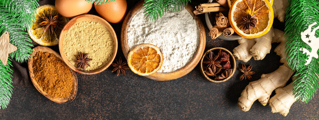 Ingredients for gingerbread cookies on the dark culinary background. Assortment of food for Christmas or New Year's holiday baking top view	