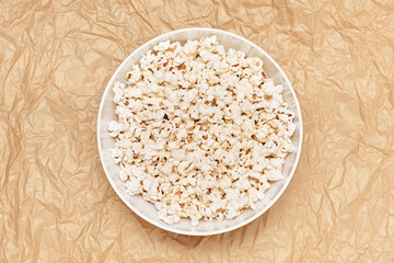 Popcorn in a bowl on craft paper