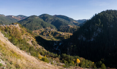 Fototapeta na wymiar A village in a valley surrounded by mountains near Zaovine on Tara Mountain, Serbia