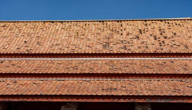 Red Clay Pantile Roofs and Brick Walls in Thailand
