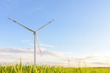 View on alternative energy windmills in a windpark in Ulyanovsk in front of a blue sky. Windmills for electric power production.