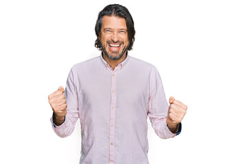 Fototapeta premium Middle age handsome man wearing business shirt excited for success with arms raised and eyes closed celebrating victory smiling. winner concept.
