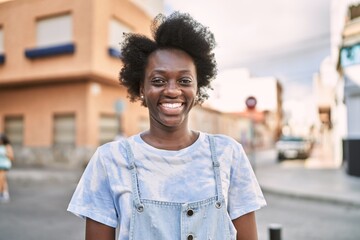 Young african woman smiling confident at street