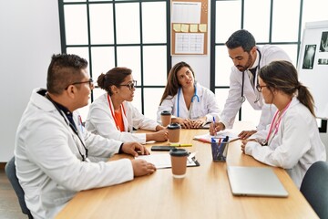 Group of hispanic doctor discussing in a medical meeting at the clinic office.