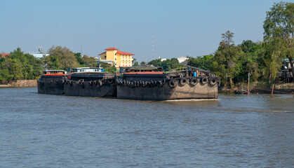 Tug boats tow barges on river in Thailand - obrazy, fototapety, plakaty