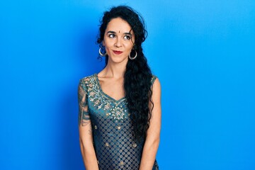 Fototapeta premium Young woman wearing bindi and traditional kurta dress smiling looking to the side and staring away thinking.