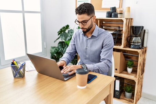 Young arab man using laptop working at office