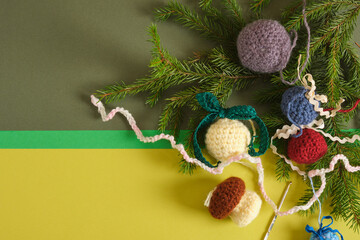 handmade. knitted balls for the Christmas tree, various crocheted Christmas toys, fir branches.