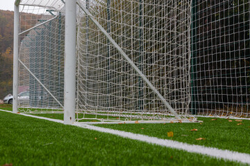 Synthetic grass for football, soccer sport field. Pattern of green artificial turf. Outdoor training play field