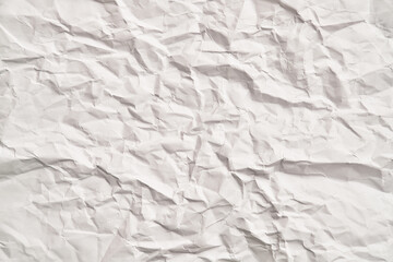White crumpled paper texture with wrinkles. Damaged and torn sheet