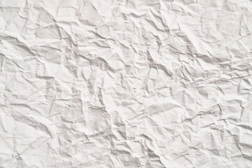 White crumpled paper texture with wrinkles. Damaged and torn sheet